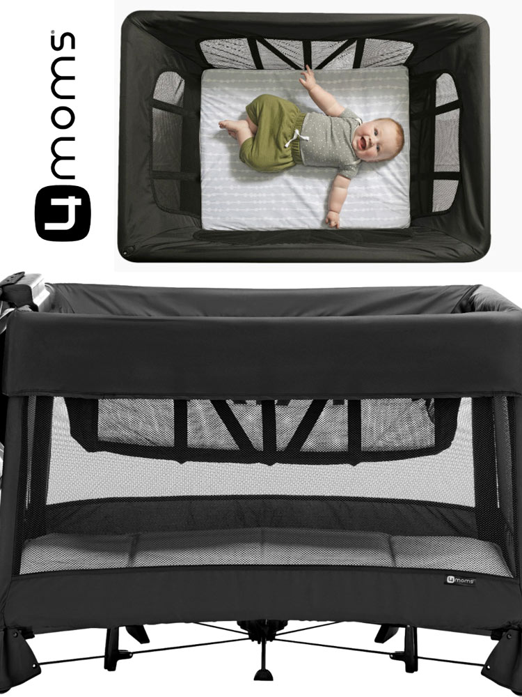 a baby laying down and smiling in the 4moms breeze plus travel crib