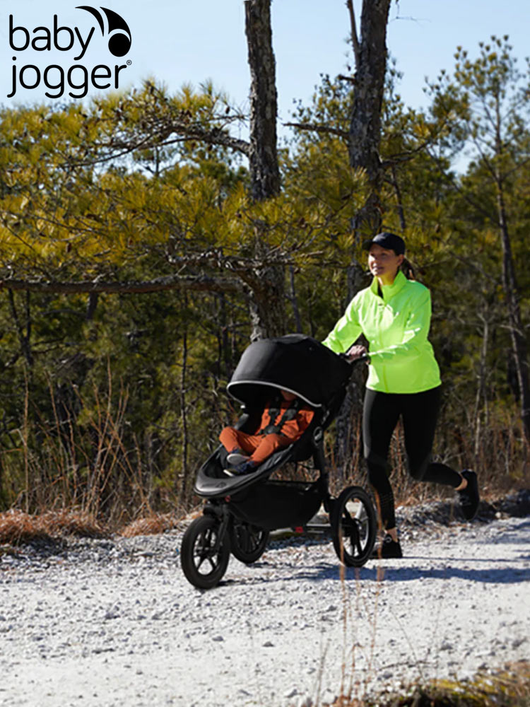 a woman jogging while pushing the baby jogger summit x3 stroller on a gravel trail