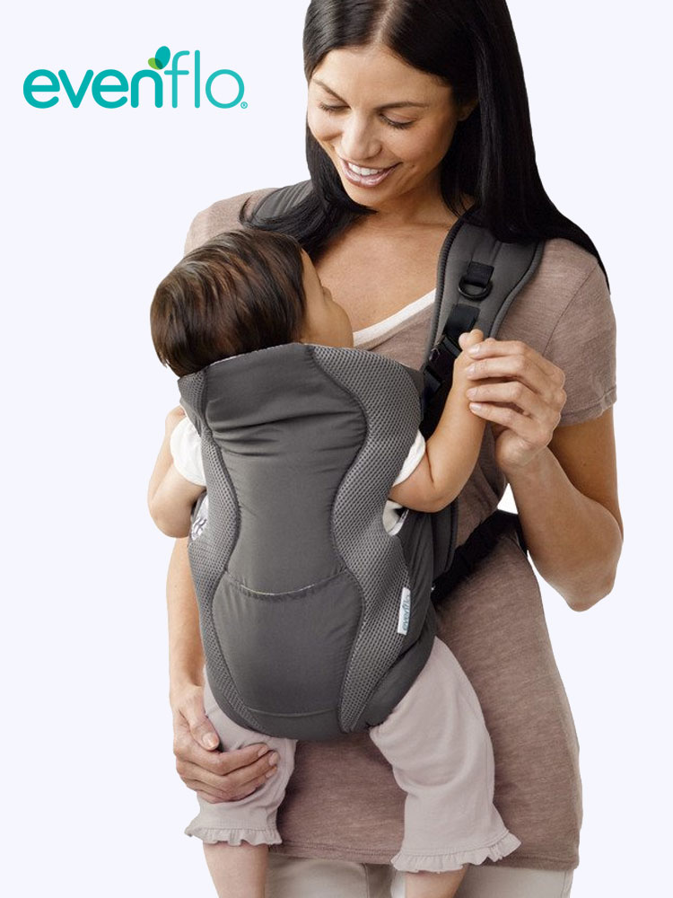 a mother carrying a baby in an evenflo breathable baby carrier