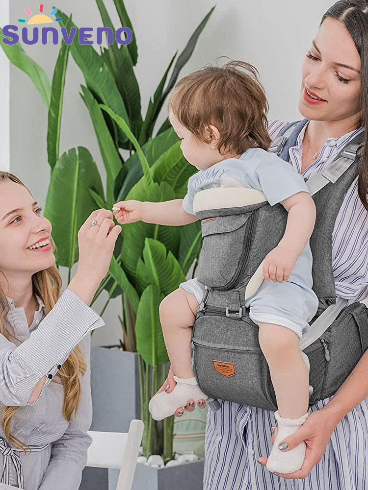 a mother and daughter with a baby carried in a sunveno hip seat carrier